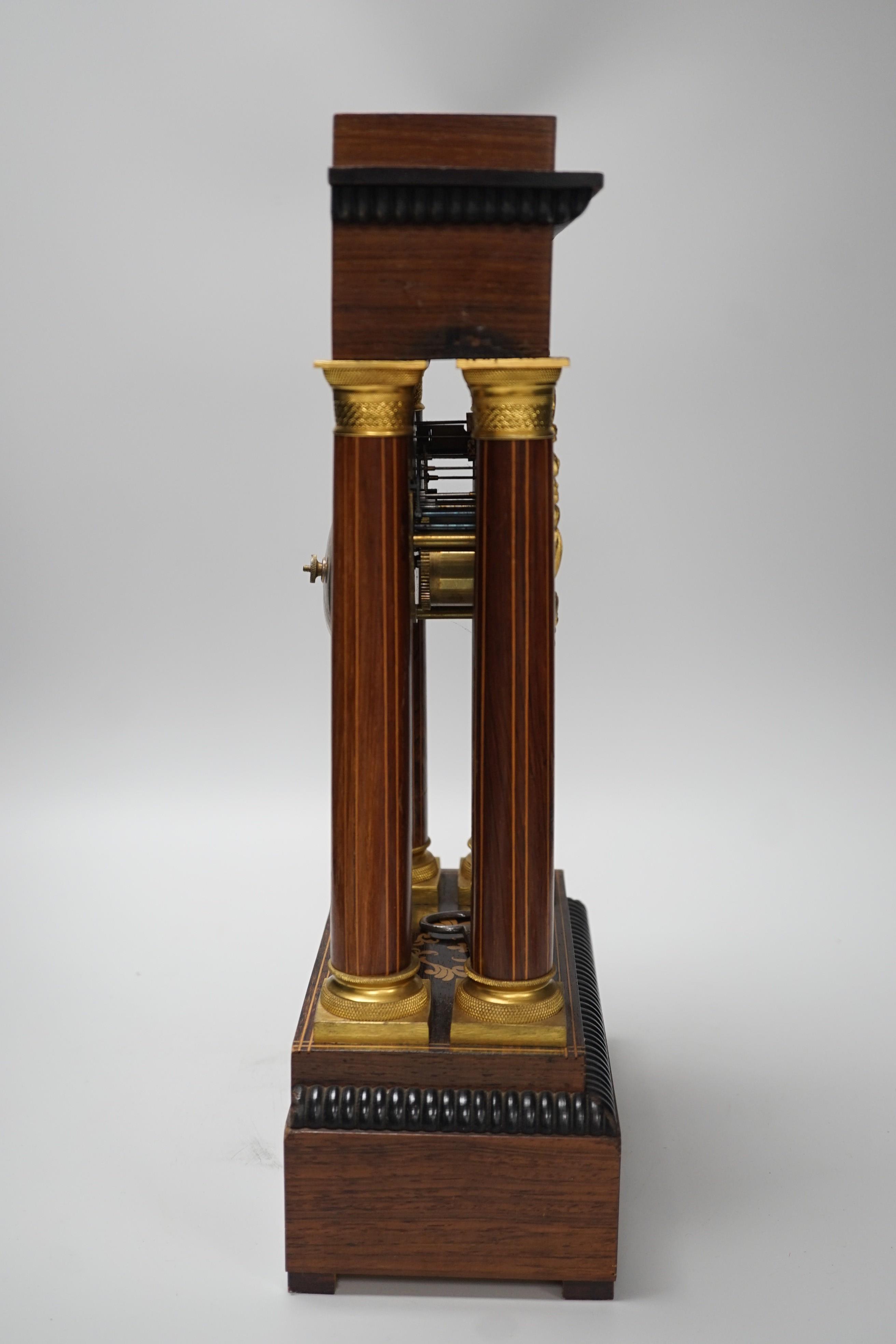 A late 19th century rosewood and marquetry portico clock with ormolu mounts